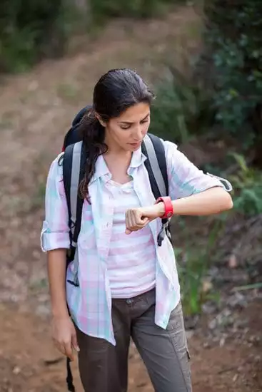 girl in white dress using smartwatch at outdoor