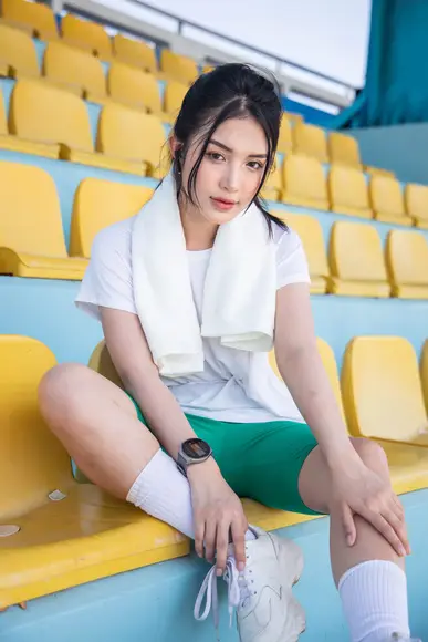 cute chinese girl in white top and socks wearing a smartwatch for fitness tracking